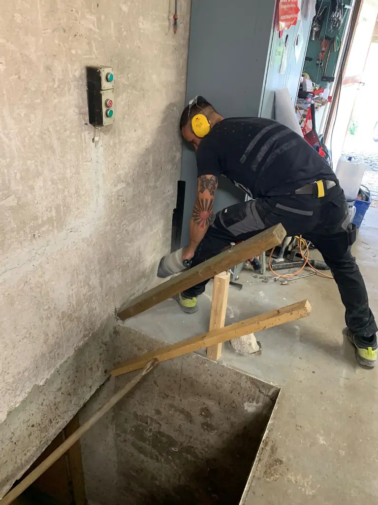 Mitarbeiter von BBS Clever setzt eine Diamantkernbohrung in eine Betonwand in Solingen